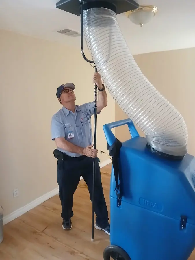 Furnace Tune-Up technician using HEPA equipment in Taos